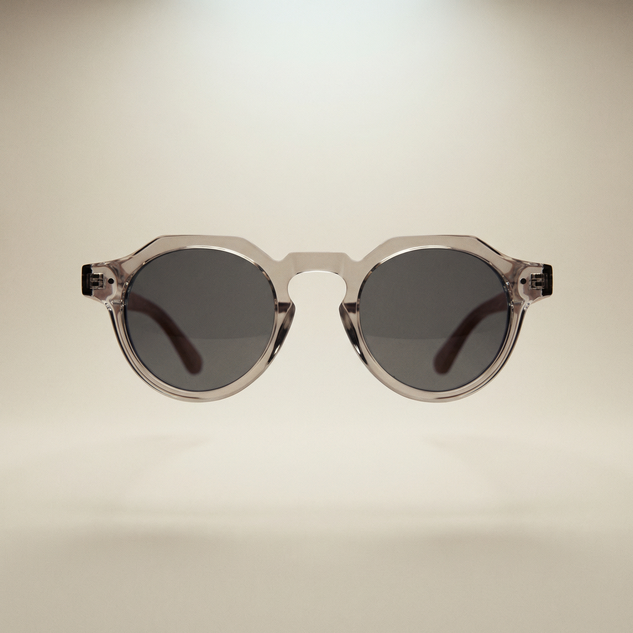 Round sunglasses with dark lenses on a beige background